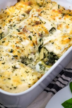 a casserole dish with spinach and cheese