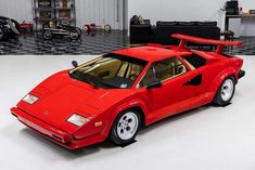 a red sports car parked in a garage