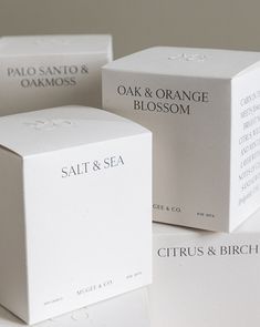 three boxes are stacked on top of each other, one containing orange blossom and the other containing salt and sea