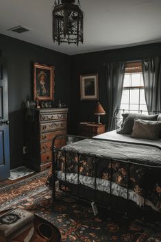 a bedroom with a bed, dresser and window in the corner next to a lamp