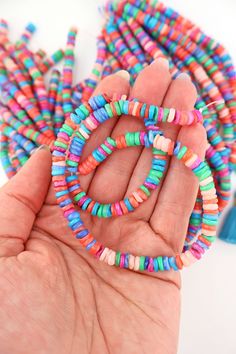 Delightfully bright and colorful, these heishi beads give off strong summer vibes. Their organic heishi shape makes them comfortable against the skin, and perfect for making beach bracelets and neckalces.The DetailsSize: Approx. 6x3mmApprox. Drilled Hole Size: 1mmMaterial: Dyed Mother of Pearl ShellColors: Assorted shades of Pink, Coral, Green, Blue, PeriwinkleStrand Length: 15.5"❤️✌🏽❤️✌🏽❤️✌🏽❤️All content (which includes all text, photography, product names, product descriptions) is All right Colorful Heishi Letter Beads, Multicolor Heart Beads For Beach, Multicolor Heishi Beads With Heart Details, Rainbow Heishi Beads Necklace, Hand-strung Heishi Beaded Necklaces For Beach, Hand-strung Heishi Beads Necklace For Beach, Bohemian Heishi Letter Beads, Bohemian Heishi Heart Beads, Multicolor Hand-strung Beads For Beach