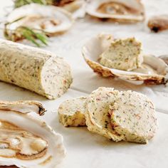 several different types of oysters on a table with herbs and seasonings in them