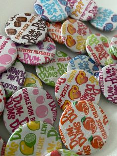 many different colored buttons on a white plate with the words dunkin donuts printed on them