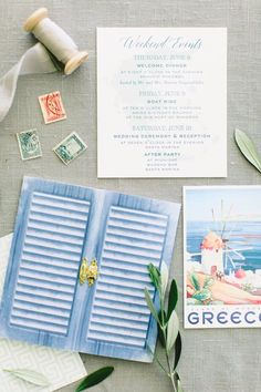 the wedding stationery is laid out with stamps and other items