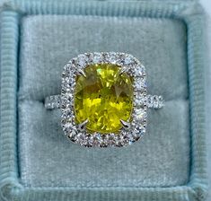 Stunning Yellow Sapphire and Diamond Ring White Gold.  This beautiful brilliant yellow sapphire is breathtaking to say the least; it is very sparkling and full of life.  This bright yellow color looks like a yellow diamond.  Sapphire is a hard gem, so it's durable for everyday wear.  The ring is excellent craftsmanship, all diamonds are set nice and smooth.  The diamonds are very sparkling.  This ring design is classy and a timeless design.  Hard to find a natural sapphire like this, not many in the market.  One Only ring! Genuine Earth Mined yellow sapphire gem 10 x 8.7mm and weighs 5.39 Carats  Excellent cut and Luster  May be heated/color enhanced Genuine earth mined Round Brilliant Cut Diamonds Total weight: 1.11 Carats  Clarity: SI Color: G All white and shiny diamonds, no cloudy or y Fine Yellow Oval Sapphire Ring, Yellow Oval Sapphire Diamond Ring, Yellow Oval Sapphire Ring With Prong Setting, Luxury Yellow Oval Sapphire Ring, Oval Yellow Sapphire Ring With Diamonds, Yellow Oval Brilliant Cut Diamond Ring, Yellow Sapphire Ring With Round Cut Gemstone, Oval Yellow Sapphire Ring With Center Stone, Dazzling Oval Yellow Ring