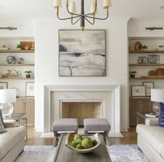 a living room filled with furniture and a fire place in front of a painting on the wall