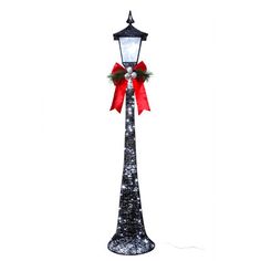 a street light with a red bow on it