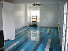 an empty room with blue and white stripes on the floor