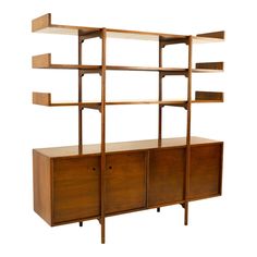 a bookcase with shelves and drawers on it, against a white background in the style of shelving