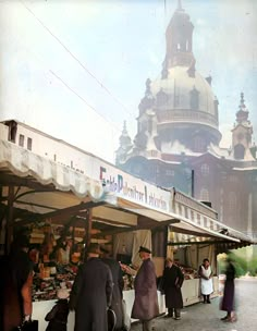 an old photo of people shopping at the market