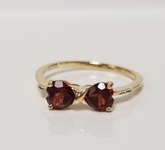 "Thanks for shopping our vintage estate store. We tend to sell well below wholesale and truly hope you enjoy all of our items. Many of the items are one of a kind, so please enjoy scrolling through the pictures and hopefully something will catch your eye. Brown spots are from reflections. Estate 14k yellow gold natural heart .50ct garnet midi or birthstone bypass ring. Ring size: 7 Setting: 5mm 1/4\" by 1/2\" Band width: 1.5mm Weight: 1.66 grams Beautiful ring. Marked 14k." Heart Garnet Ring, Red 14k Gold Heart Ring With Gemstone, Garnet 3 Stone 18k Gold Ring, Gold Heart-shaped 14k Gold Ruby Ring, Gold Garnet Multi-stone Ring, Rose Gold Heart Ring, 14k Gold Signet Ring, 1ct Diamond Ring, Gold Initial Ring