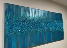 a large blue painting hanging on the wall