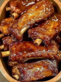 some chicken wings in a wooden bowl on a table