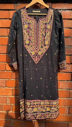 This is a one of a kind piece in size S only. Perfect for a mehendi/haldi/dholki, or a girl's night out. The delicate pink floral embroidery gives it a beautiful feminine look.  1Piece .  Dry clean only, with medium iron NO RETURNS. Black Cotton Silk Traditional Wear With Resham Embroidery, Black Traditional Wear With Resham Embroidery In Cotton Silk, Tussar Silk Straight Kurta With Dabka Work, Transitional Season Tussar Silk Kurta With Dabka Work, Transitional Tussar Silk Kurta With Dabka Work, Traditional Tussar Silk Kurta With Dabka Work, Festive Tussar Silk Kurta With Dabka Work, Transitional Traditional Wear With Dabka Work In Tussar Silk, Transitional Raw Silk Kurta With Chikankari Embroidery