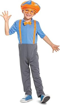 a young boy dressed in an orange hat and suspenders, with his hands out