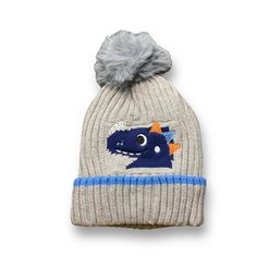 a gray hat with a blue and orange dragon on it's side, next to a grey pom - pom