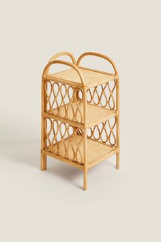 a small bamboo shelf with two baskets on each side and an open drawer in the middle