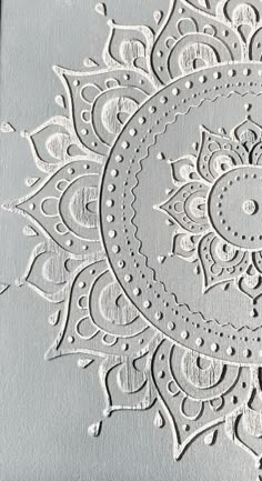 an intricately designed piece of paper with white embossings on it's surface