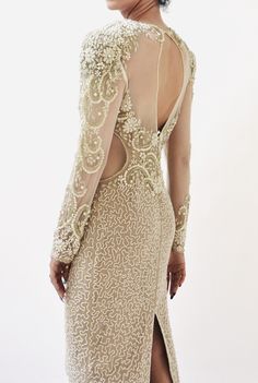 the back of a woman's dress with sheer sleeves and an open - front slit