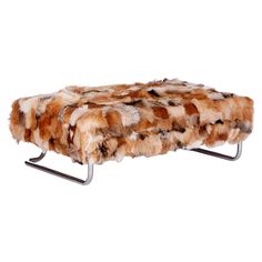 a bench made out of fur with metal legs and footrests on the bottom