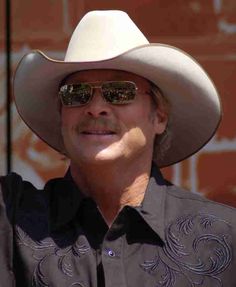 a man wearing a cowboy hat and sunglasses