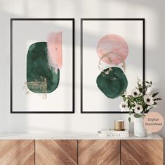 two abstract paintings on the wall above a dresser