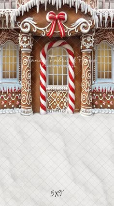 a gingerbread house with candy canes and icing on the front door is decorated for christmas