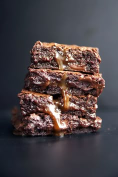 three brownies stacked on top of each other with caramel drizzle