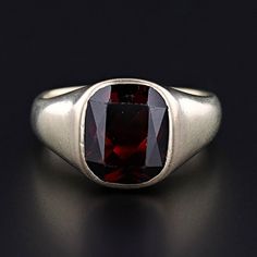 This vintage ring (circa 1925-1935) features a radiant cut almandine-spessarite garnet set in pale 14k yellow gold. The ring is currently a size 9, but it can be resized free of charge. It is in very good condition with light surface wear to the gold and to the facets of the garnet.  The ring weighs 9.87 grams.  We have many other fantastic offerings of period fine jewelry posted on our Etsy store, so please consider browsing our other items. We send all items in individually packaged gift boxes and offer layaway plans! + Trademark Antiques Shop Homepage https://www.etsy.com/shop/TrademarkAntiques + Our Store Policies https://www.etsy.com/shop/TrademarkAntiques/policy?ref=shopinfo_policies_leftnav + Connect with us on Social Media (Get access to monthly giveaways, special sales, and sneak Formal Garnet Ring With Center Stone, Classic Formal Gemstone Signet Ring, Classic Formal Signet Ring With Gemstone, Formal Garnet Rings Fine Jewelry, Formal Ruby Signet Ring In Fine Jewelry Style, Ruby Signet Ring Fine Jewelry For Formal Events, Fine Jewelry Ruby Signet Ring For Formal Occasions, Classic Red Signet Ring For Formal Occasions, Formal Garnet Birthstone Ring In Fine Jewelry Style