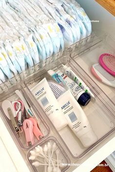 an organized drawer filled with baby items such as toothbrushes, combs and diapers