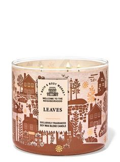 an image of a candle that is in the shape of a house with trees and houses on it