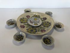 an assortment of bowls and plates with designs on them