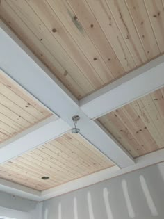 an unfinished ceiling with wood planks and white paint