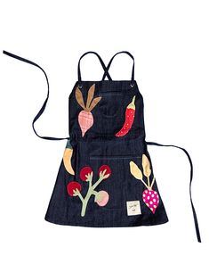 an apron made out of denim with embroidered vegetables on the front and back, hanging from a string