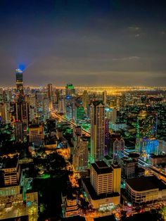 the city lights shine brightly at night in this aerial view from an observation point on top of a skyscraper