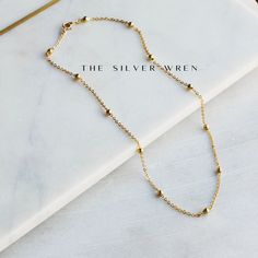 This dainty gold chain necklace, perfect for layering or a minimalist look. •18kt gold plated -lead, nickel & cadmium free•Heavy plating, tarnish resistant, water friendly Minimalist Adjustable Chain Necklace With Round Beads, Minimalist Adjustable Round Bead Chain Necklace, Minimalist Chain Necklace With Adjustable Chain And Round Beads, Dainty Gold Beaded Necklace With Delicate Chain, Minimalist Gold Beaded Necklaces With Tiny Beads, Dainty Ball Chain Necklace For Everyday, 14k Gold Filled Beaded Chain Necklace, Dainty Beaded Chain Charm Necklace For Everyday, Minimalist Gold Plated Satellite Chain Necklace