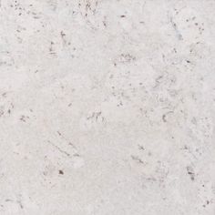 a white marble counter top with brown speckles