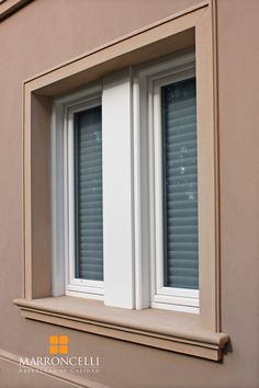 an open window on the side of a building with blind shades in it's windows