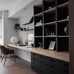 an office with black and white decor in the corner