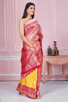 Radiate elegance on special occasions in this pink and yellow Banarasi saree with zari minakari border and heavy zari pallu. It comes with a blouse piece. Disclaimer: The shown stitched blouse on the model is for display purpose only. The saree comes with a matching blouse piece and finished with fall and piko. Yellow Banarasi Saree, Banarasi Sari, Tussar Silk Sarees, Fashion Journals, Tussar Silk Saree, Traditional Fabric, Banarasi Saree, Banarasi Sarees, Pure Silk Sarees