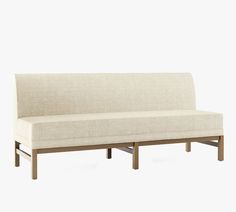 a white couch sitting on top of a wooden frame