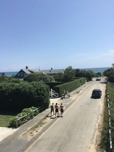 some people walking down the side of a road