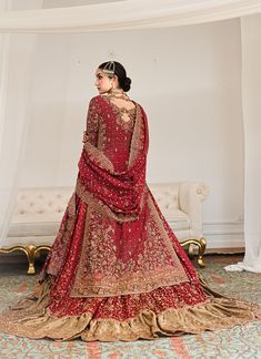 Burgundy Pakistani Bridal Dress in Lehenga Kameez Style is a breathtaking attire adorned with hand-crafted detail of Gota, Zardosi, Naqshi, and Dabka kora.