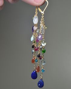 "These Earrings are a beautiful composition of Stunning Gemstones that are presented to You in a \"Rainbow\" of Colors: It will bring a smile to your recipient's face and it sure to go with any outfit! Each Earring features 14 Unique Gemstones in a variety of shapes and sizes. This gives the earrings lots of character and each gemstone is individually hand wired for a more bohemian look and feel. >Rainbow, Rainbow Statement Earrings, Chain Drop Earrings, Gemstone Earrings, Duster Earrings, Lo Fine Jewelry Multi-stone Drop Earrings, Elegant Multi-stone Long Drop Jewelry, Elegant Long Drop Multi-stone Jewelry, Elegant Multi-stone Drop Jewelry, Multi-stone Dangle Earrings For Party, 14k Gold Multi-stone Drop Earrings, Elegant Multi-stone Dangle Jewelry, Fine Jewelry Multi-stone Dangle Earrings, Dangle Multi-stone Earrings For Gifts