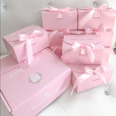 several pink boxes with bows on them