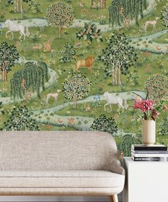 a green wallpaper with animals and trees in the background, along with a couch