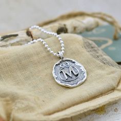 An initial or monogram is a sign of identity. Wear it to show off your own beautiful identity or wear several to show off those who have created a lasting impression in your heart. Our Lasting Impressions Necklace comes to you in handcrafted sterling silver and on a 16" chain. If you prefer a longer length, you can select 18, 20, 24 or 30 inches for a small additional fee. This designer monogram necklace replicates the the lost art of wax seals to identify the writer. Each silver monogram is cre Personalized Symbolic Necklaces For Everyday, Personalized Symbolic Initial Pendant Necklace, Personalized Sterling Silver Initial Necklace, Custom Initial Pendant Necklace As Personalized Gift, Personalized Adjustable Sterling Silver Initial Necklace, Personalized Symbolic Sterling Silver Jewelry, Custom Necklace With Initial Pendant For Personalized Gift, Symbolic Sterling Silver Jewelry With Initials, Symbolic Sterling Silver Charm Necklace With Personalization