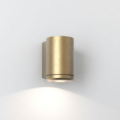 a light that is on the side of a wall with white walls and flooring