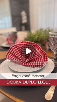 a table setting with red and white checkered napkins