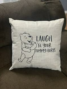 a winnie the pooh pillow that says laugh it's your tummy hurts